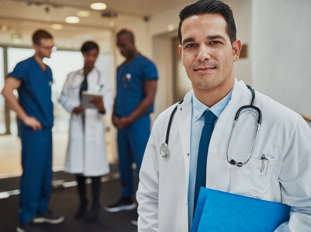 male-doctor-with-colleagues-in-background-4WTSKH8_1024x1024